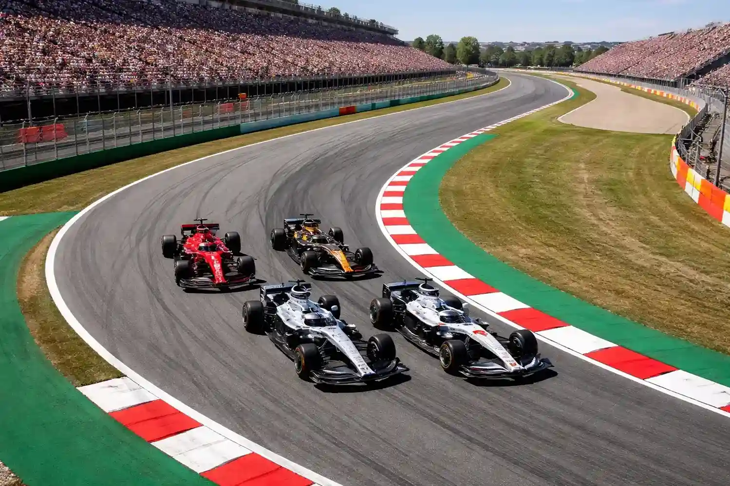 Monoplazas de Fórmula 1 en una curva de un circuito durante una carrera del campeonato mundial